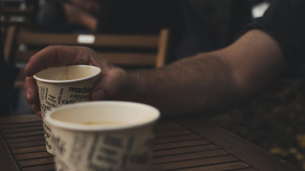 man holding coffee cup